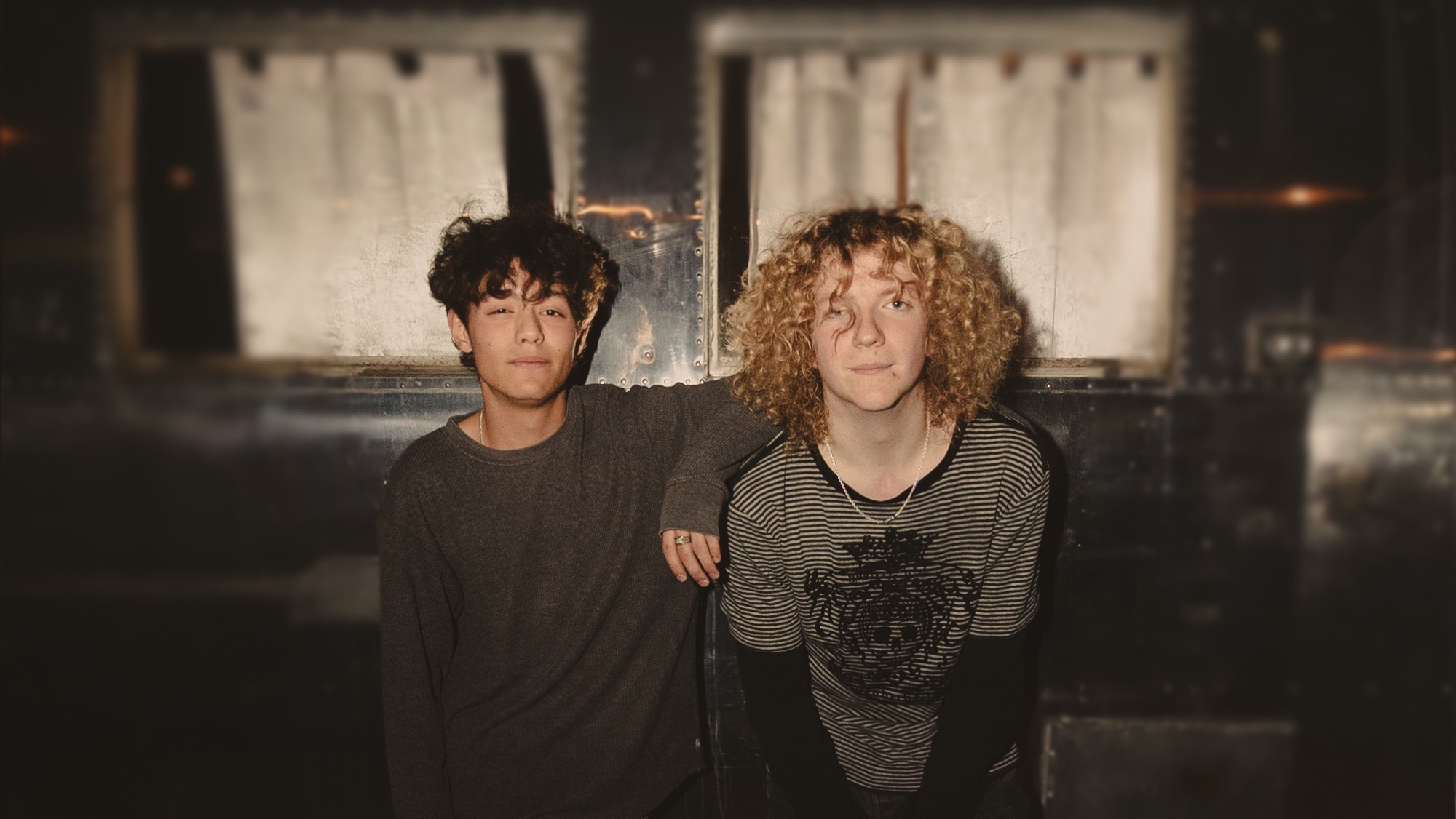 Dylan Frechette and Declan Scully in front of a vintage trailer